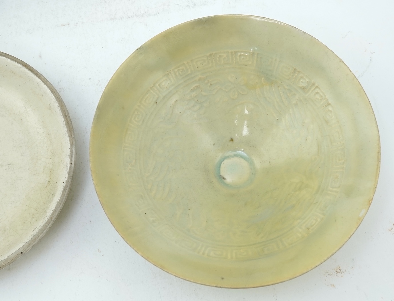 A Chinese Ding type circular dish, Song dynasty and a qingbai moulded conical bowl, Song-Yuan dynasty
